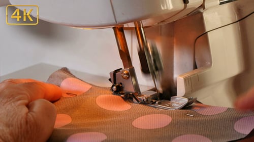 Seamstress Sews Clothes with her Over Lock Machine 4K