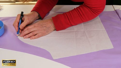 Adult Creating Pattern on Lilac Fabric