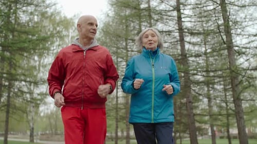 Active Senior Couple Jogging in Urban Park