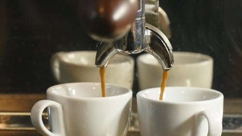 Espresso Pouring into Two Cups Close Up