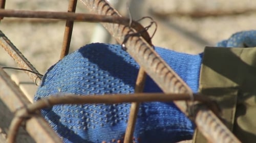 Construction Worker Securing Rebar with Wire