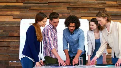 Team Collaborating at Table in Modern Workplace