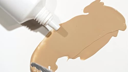 Foundation Cream Being Spread with Metal Tool