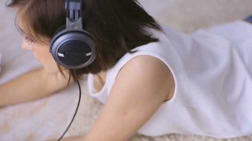 Young Adult Woman Lying Down Using Laptop