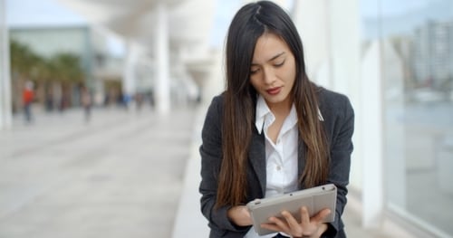 Woman Using Tablet in Urban Environment