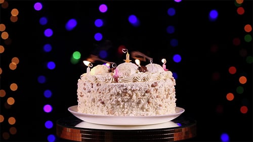 Festive Cake with Candles on a Rotating Stand