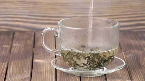 Brewing Herbal Tea in Clear Glass Cup