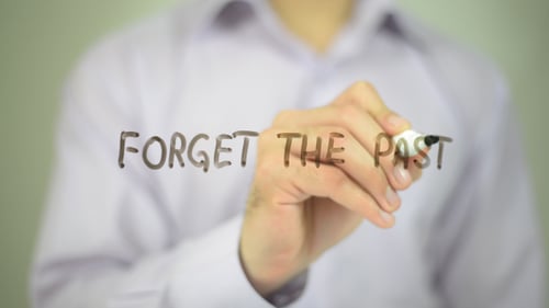 Man Writing the Phrase Forget the Past