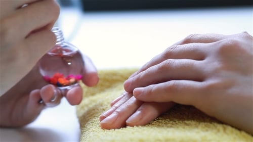 Woman Using a Cuticle Pusher
