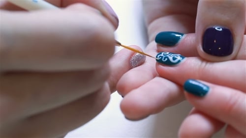 Hands Applying Artistic Nail Design Close Up