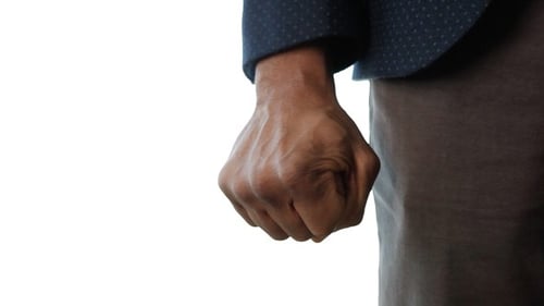 Close up of hand clenching into fist