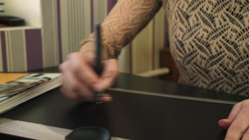 Woman Uses Pen on Digital Tablet Close Up