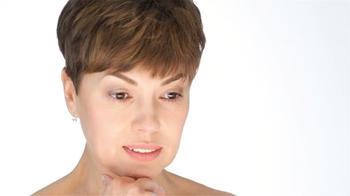 Woman Touching Chin in Bright Studio Lighting