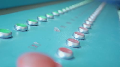 Close Up of Green and Red Control Panel Buttons