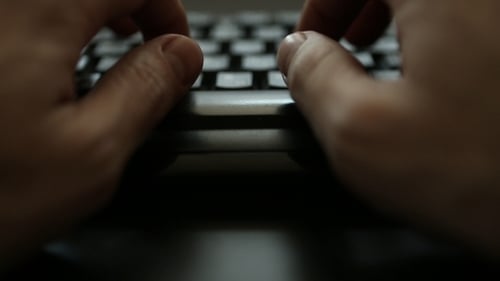 Hand Over Keyboard in Dark Room