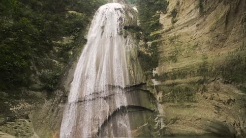 Majestic Waterfall Cascading Through Lush Tropical Nature