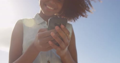 Woman using mobile phone in the beach 4k