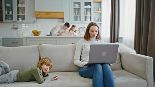 Professional Female Manager Video Chatting with Clients Via Laptop Working at Home Interior with