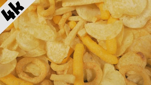 Close-Up of Fried Yellow Potato Chips and Snacks