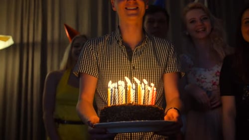Smiling Friends Celebrate Birthday with Cake and Candles