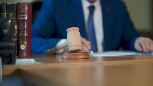 Gavel in Courtroom with Judge Writing
