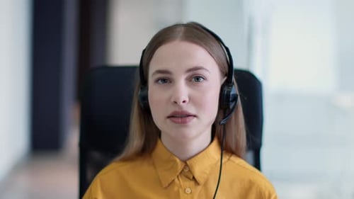 Young Woman Using Headset in Corporate Setting