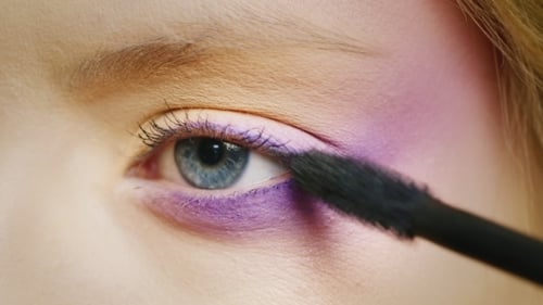 Applying Purple Mascara to Lower Eyelashes