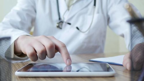 Doctor Working On Tablet Pc