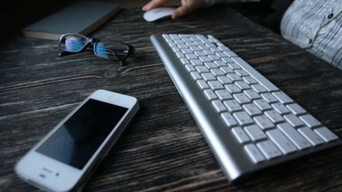 Typing on Keyboard on Wooden Desk at Work