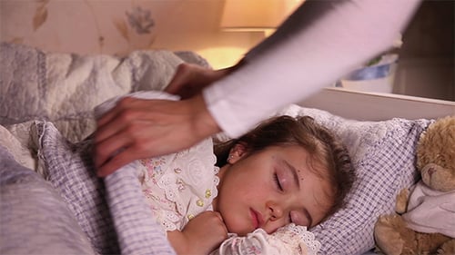 Mother Puts Her Daughter To Bed