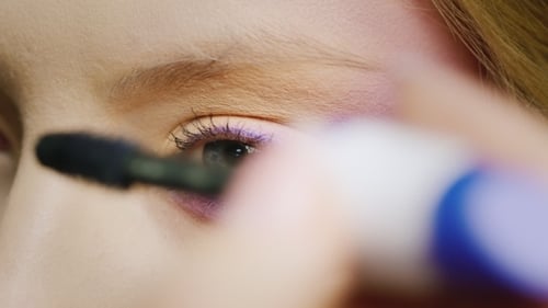 Woman Applying Mascara to Eyelashes Close-up