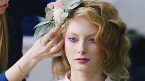 Woman Gets Hair Styled with Floral Arrangement
