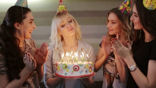 Young Women Celebrate Birthday and Blow Out Candles