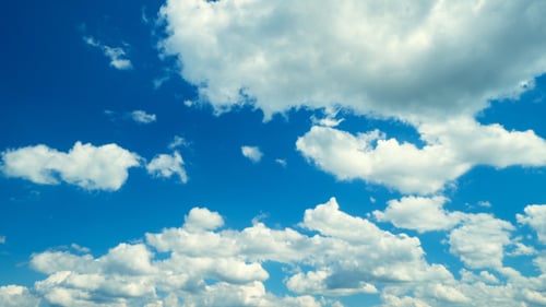 White Clouds Drifting in Bright Blue Sky