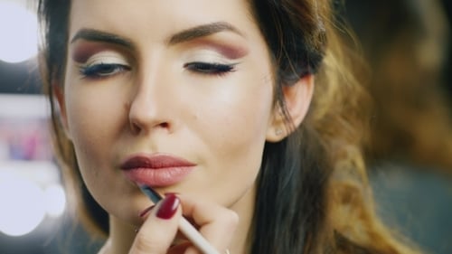 Woman Receives Lip Makeup in Beauty Studio