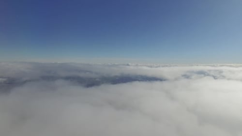 The Airplane Is Flying Above The Clouds