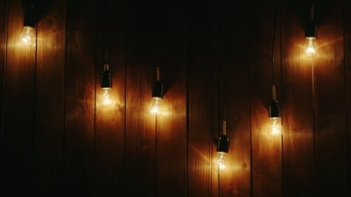 Garland Of Light Bulbs On a Wooden Background