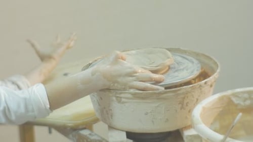 Hands Molding Clay on a Pottery Wheel