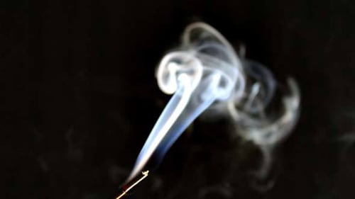 Swirling White Smoke Against Black Background
