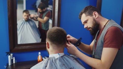 Barber Giving a Haircut to a Customer