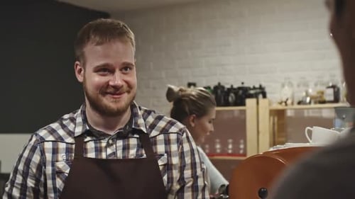 Barista Serving Coffee in Cafe