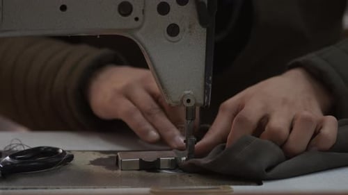 Tailor Sews Trousers On The Sewing Machine 4