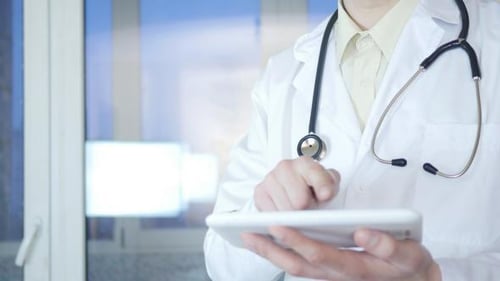 Doctor Using Tablet in Hospital Setting