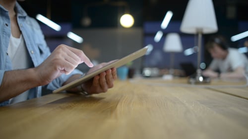 Young Adult Using Tablet in Modern Office