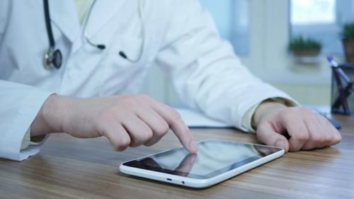 Doctor Using Tablet Computer in Hospital