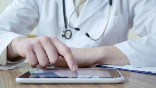 Doctor Typing On Tablet 04