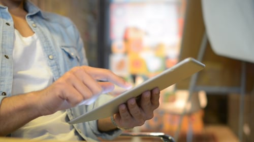 Person Taps Tablet Screen Indoors Close Up