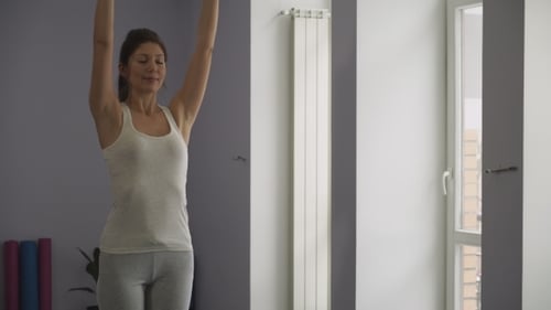 Woman Practicing Yoga in Bright Room