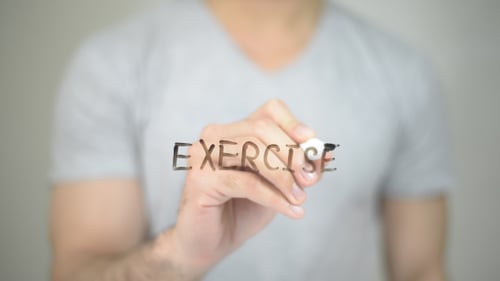 Man Writes Exercise on Clear Surface