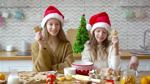 Girls Baking Christmas Cookies in a Festive Kitchen